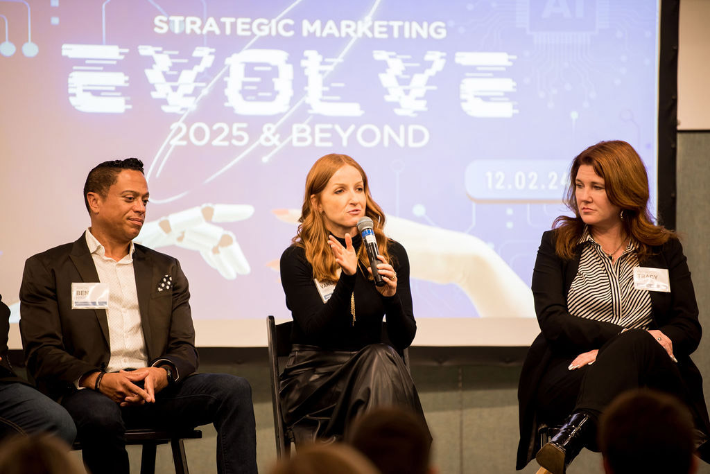 Vanessa Errecarte sitting between two other speakers on an expert panel at a Marketing Conference